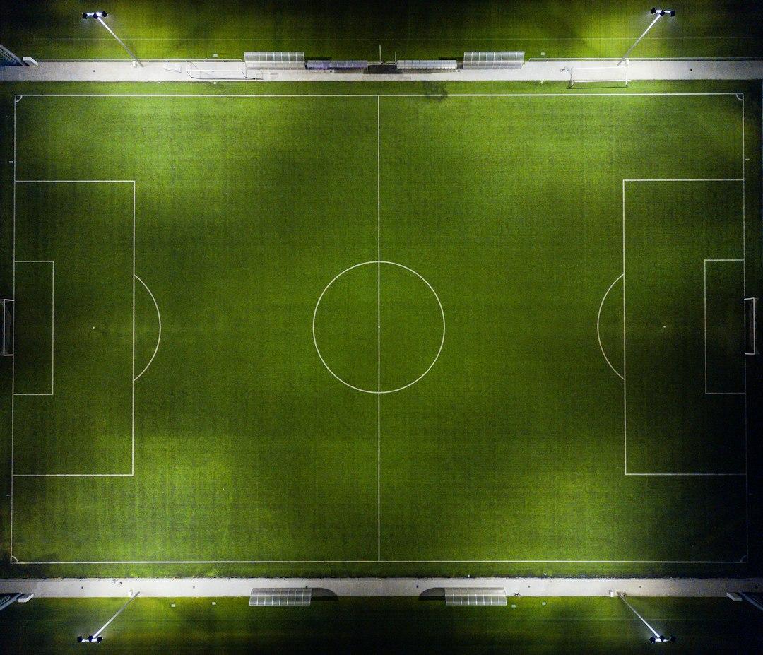 Aerial view of a football pitch under floodlights